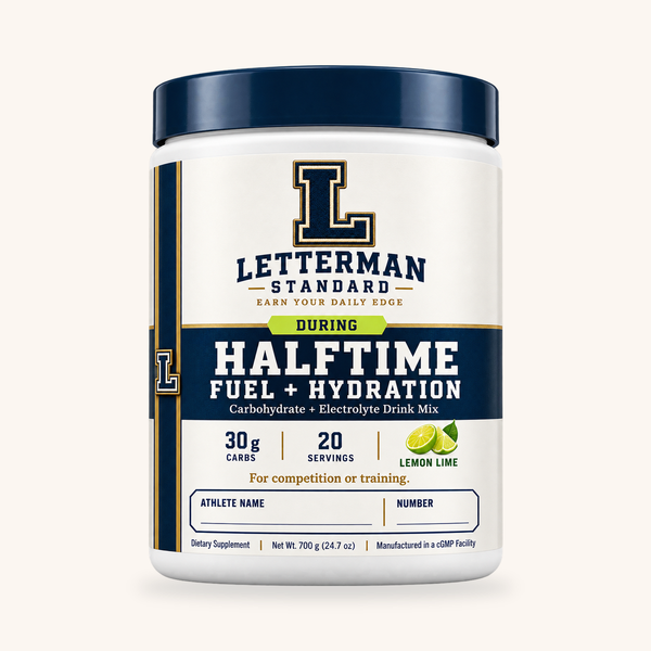 Halftime Fuel + Hydration Lemon Lime 20-serving tub on a warm cream background.