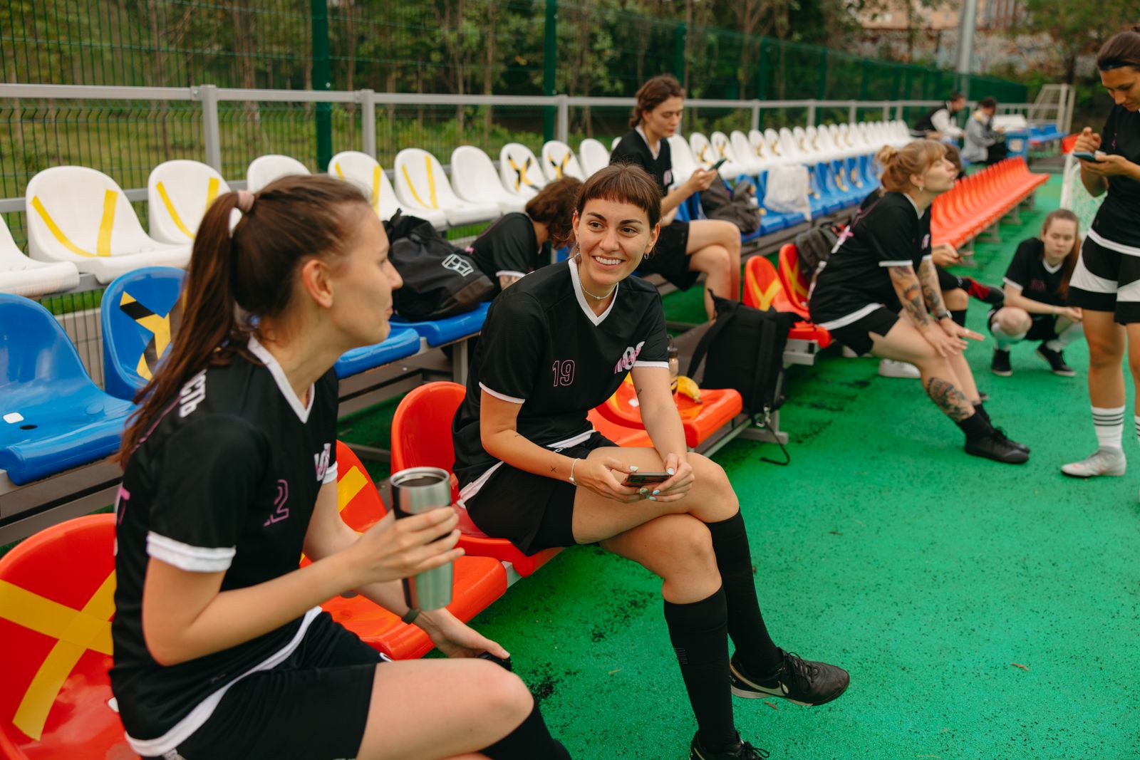 Women soccer players on the sideline during a practice or game